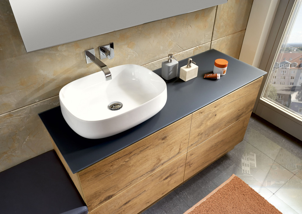 Photo of a contemporary bathroom in Other with medium wood cabinets and a vessel sink.