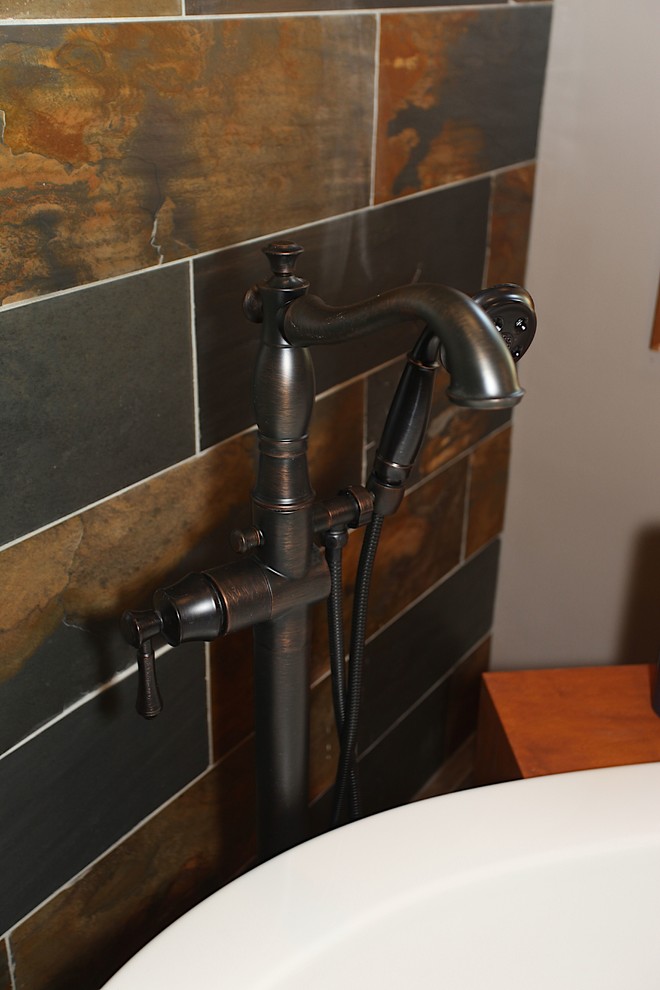 Example of a large mountain style master slate tile brown floor home design design in Indianapolis with brown cabinets, beige walls and an undermount sink