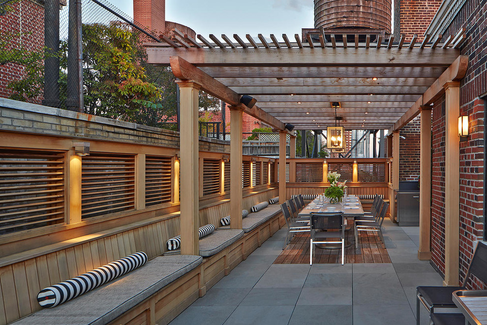 Photo of a traditional rooftop and rooftop deck in New York with a pergola.