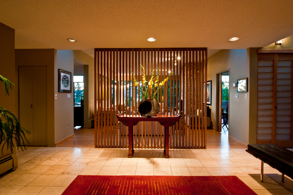 Large modern foyer in Vancouver with green walls, travertine floors, a single front door, a medium wood front door and beige floor.