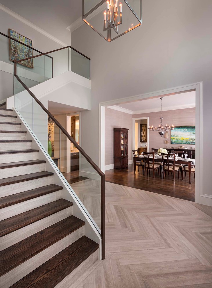 Photo of a transitional wood l-shaped staircase in Dallas with glass railing and tile risers.