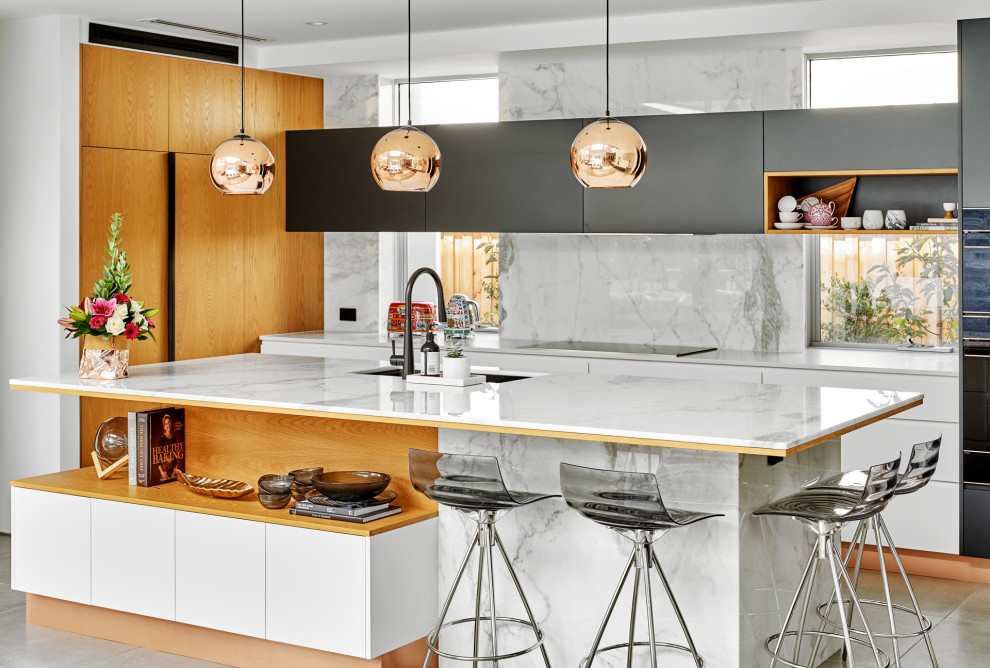 Design ideas for a large contemporary l-shaped kitchen in Sydney with an undermount sink, flat-panel cabinets, white cabinets, solid surface benchtops, grey splashback, porcelain splashback, panelled appliances, porcelain floors, with island, grey floor and white benchtop.