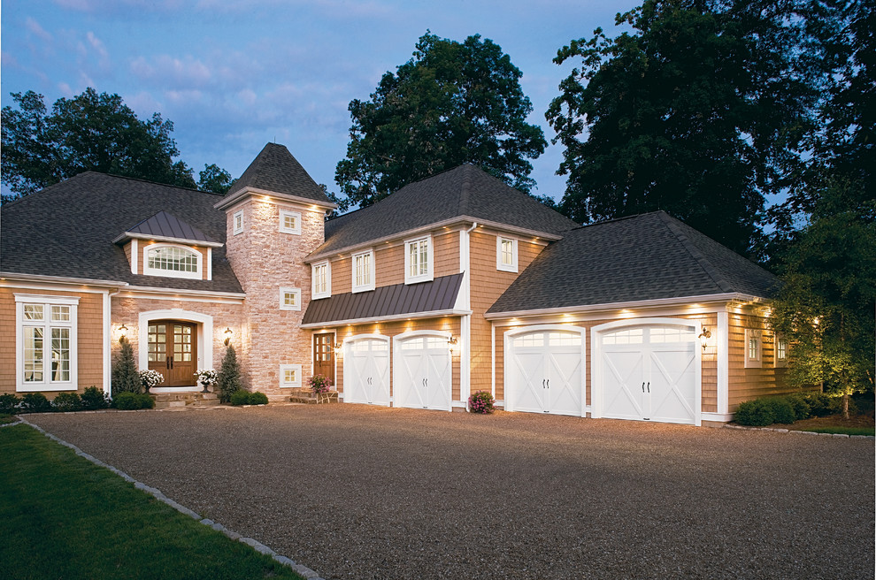 Photo of an expansive transitional attached three-car garage in Cincinnati.