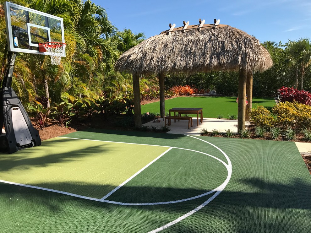 This is an example of an expansive tropical backyard outdoor sport court in Jacksonville.