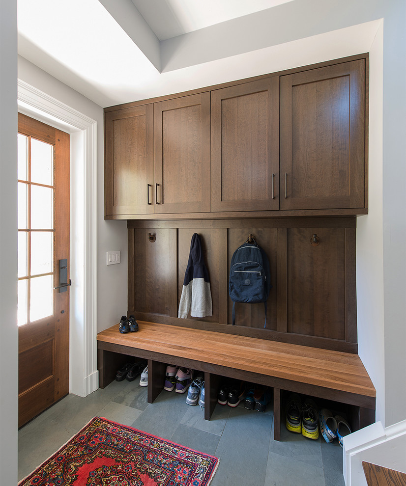 This is an example of a traditional mudroom in DC Metro with grey walls, slate floors, a single front door, a medium wood front door and grey floor.