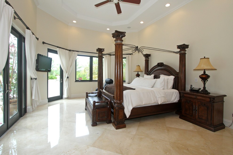 Large traditional master bedroom in Houston with beige walls, marble floors and no fireplace.