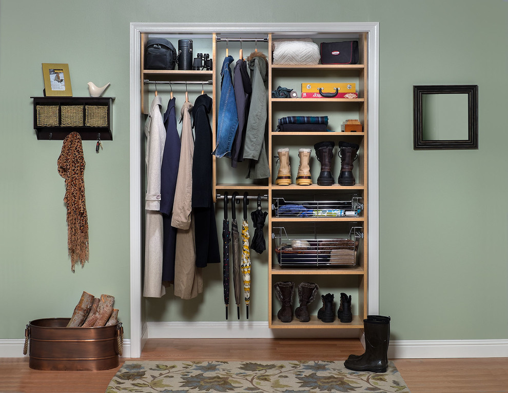 This is an example of a small transitional gender-neutral built-in wardrobe in Denver with flat-panel cabinets, light wood cabinets and medium hardwood floors.