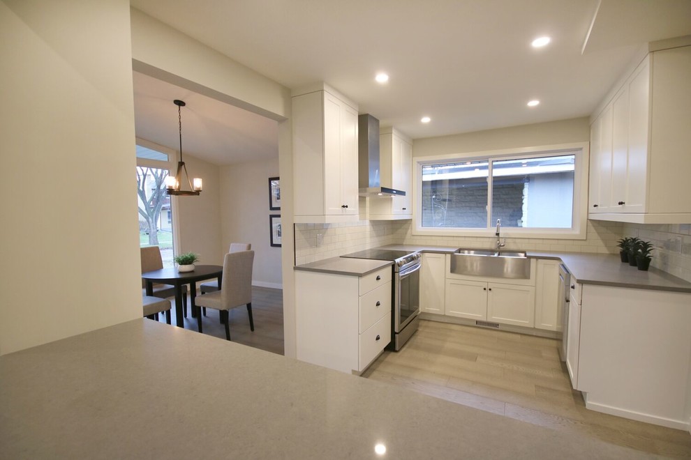 Porcelain tile kitchen photo with quartz countertops, ceramic backsplash and gray countertops