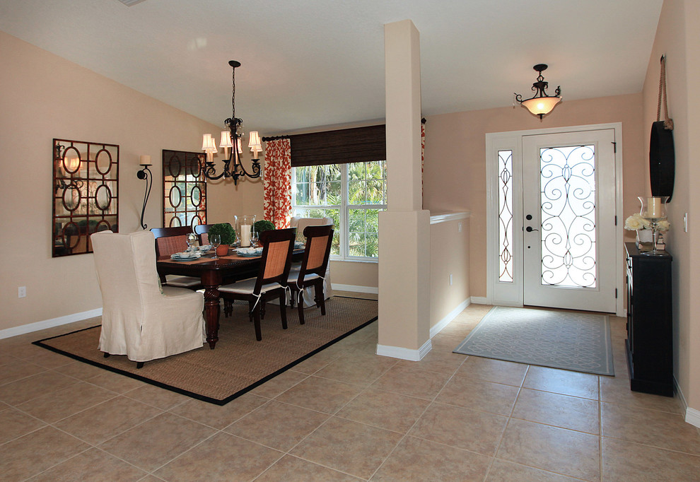 Front door - large transitional ceramic tile and beige floor front door idea in Orlando with beige walls and a glass front door