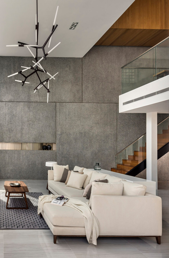 Expansive contemporary formal open concept living room in Singapore with grey walls and grey floor.