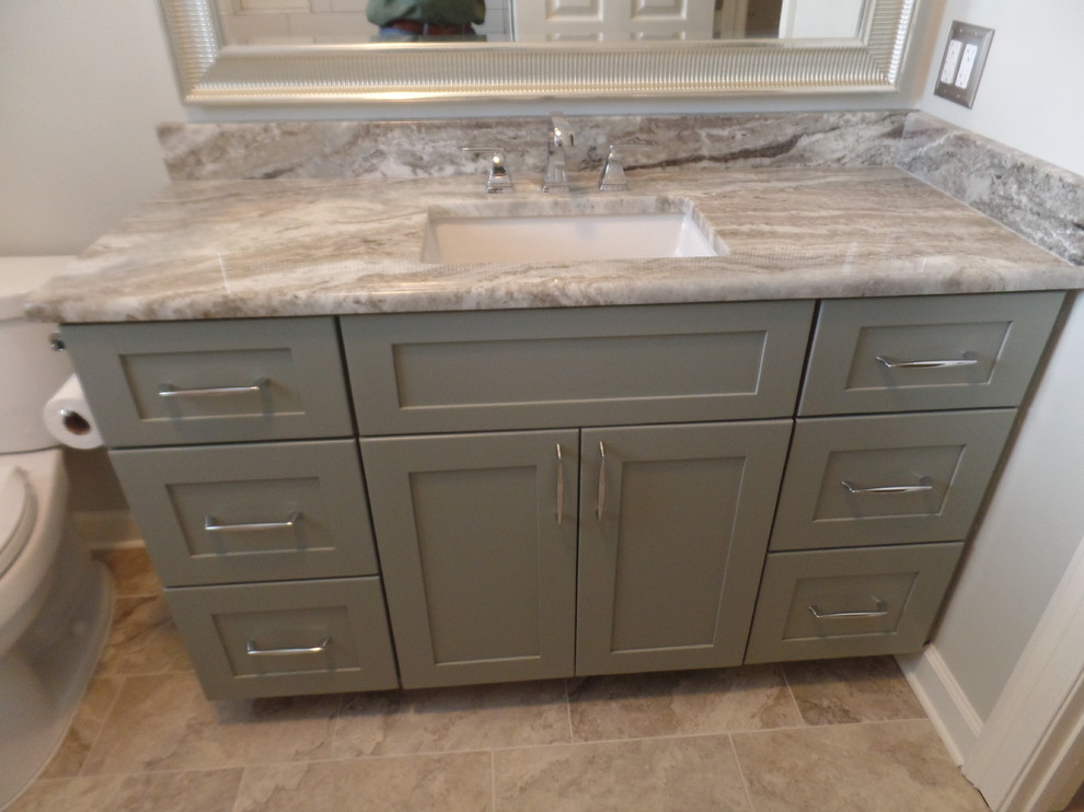 Mid-sized transitional kids' white tile and ceramic tile porcelain tile and gray floor home design photo with shaker cabinets, green cabinets, a two-piece toilet, gray walls, an undermount sink, marble countertops and a hinged shower door
