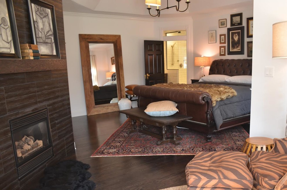 Mid-sized transitional master dark wood floor and brown floor bedroom photo with white walls, a standard fireplace and a wood fireplace surround