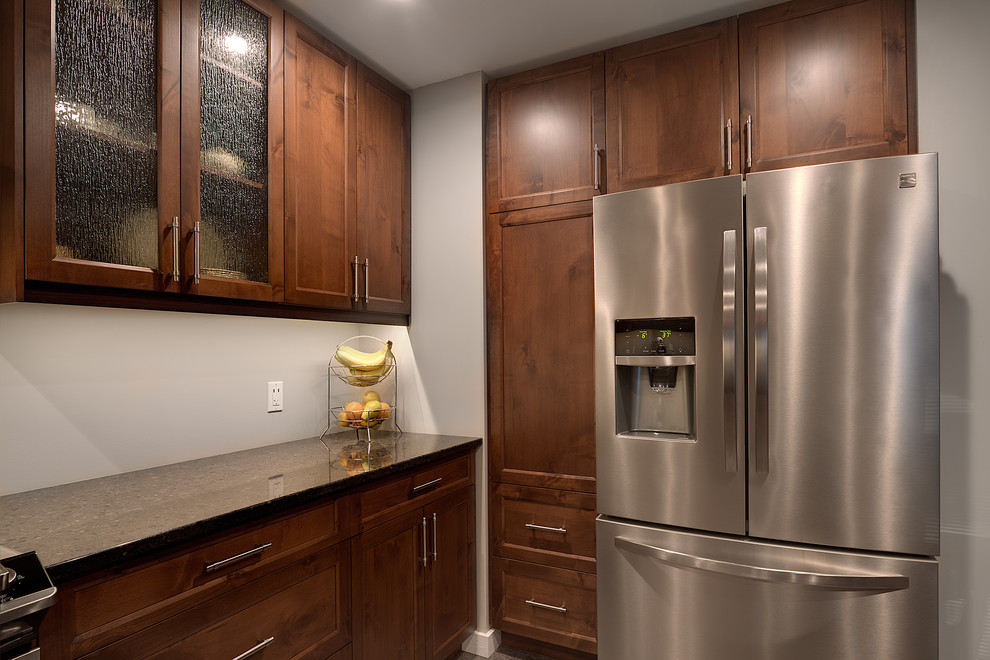 Mid-sized transitional kitchen photo with shaker cabinets, medium tone wood cabinets, quartz countertops, stainless steel appliances and an island
