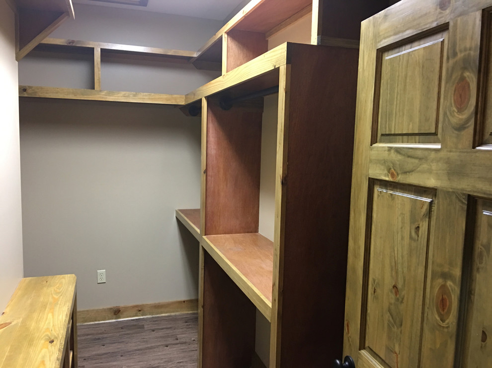 Mid-sized mountain style gender-neutral dark wood floor and brown floor dressing room photo with open cabinets and medium tone wood cabinets