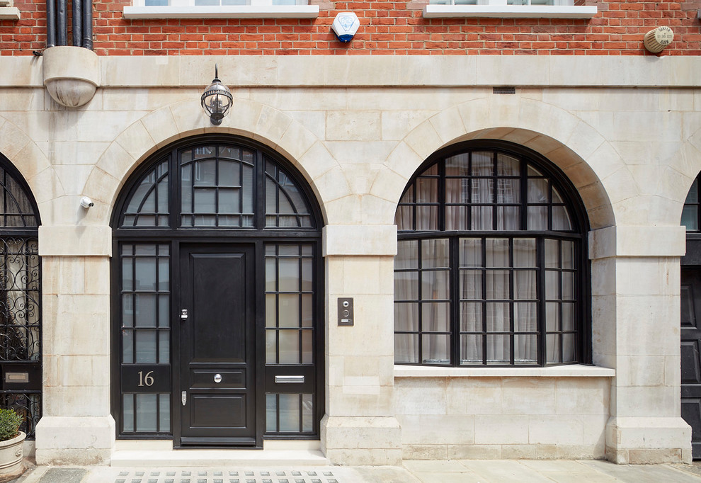 Design ideas for a traditional front door in London with beige walls, a single front door, a black front door and beige floor.
