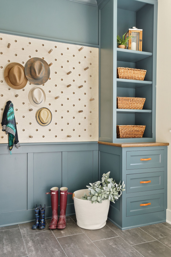 Beach style mudroom in Minneapolis with blue walls and grey floor.
