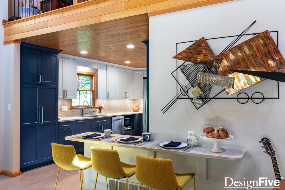 Large minimalist u-shaped gray floor and wood ceiling open concept kitchen photo with an undermount sink, shaker cabinets, blue cabinets, quartz countertops, gray backsplash, ceramic backsplash, stainless steel appliances and no island