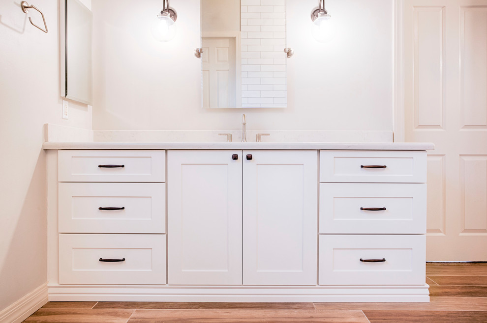 Freestanding bathtub - huge transitional master brown tile and porcelain tile porcelain tile freestanding bathtub idea in Phoenix with shaker cabinets, white cabinets, a two-piece toilet, gray walls, an undermount sink and quartzite countertops