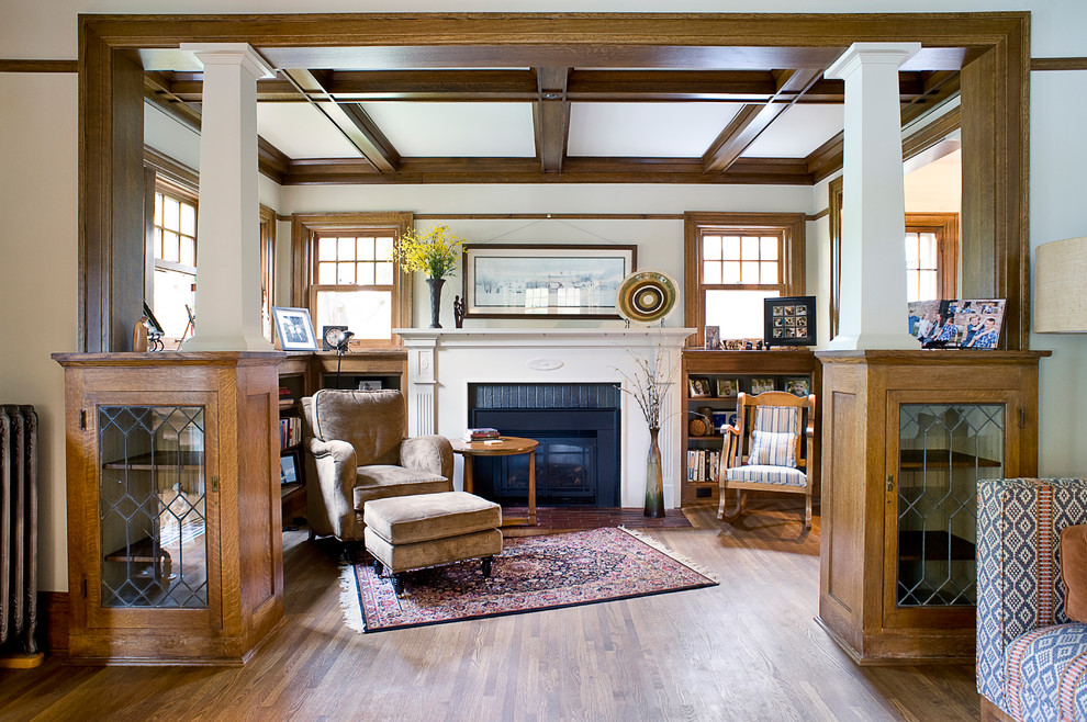 Inspiration for an arts and crafts living room in Other with white walls, dark hardwood floors, a standard fireplace, a brick fireplace surround and brown floor.