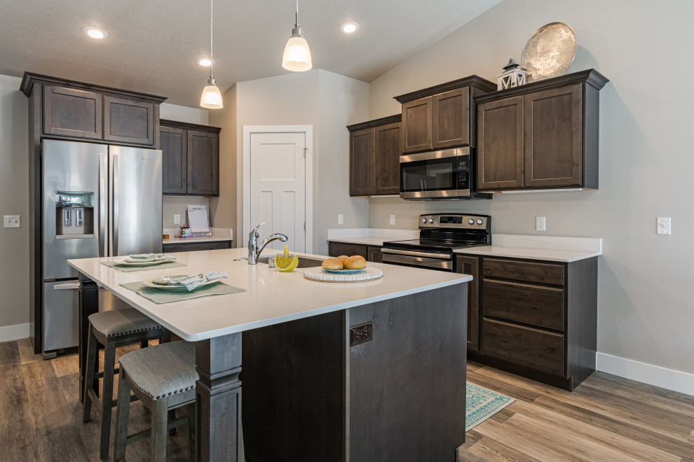 Eat-in kitchen - mid-sized transitional l-shaped vinyl floor and gray floor eat-in kitchen idea with an undermount sink, shaker cabinets, dark wood cabinets, quartz countertops, quartz backsplash, stainless steel appliances, an island and white countertops