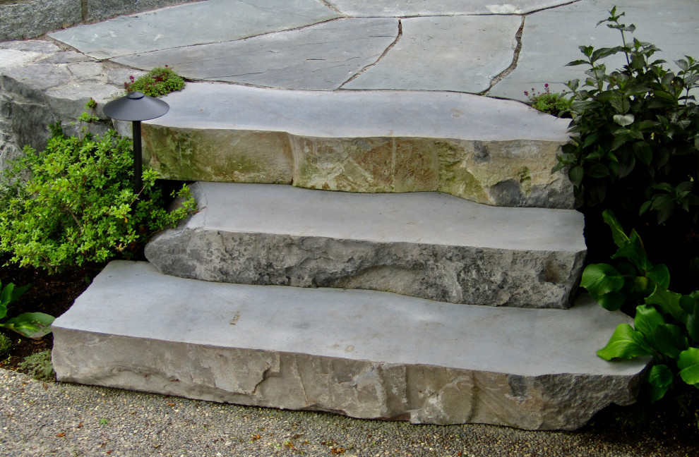 Photo of a coastal front partial sun garden in Vancouver with a rockery and natural stone paving.