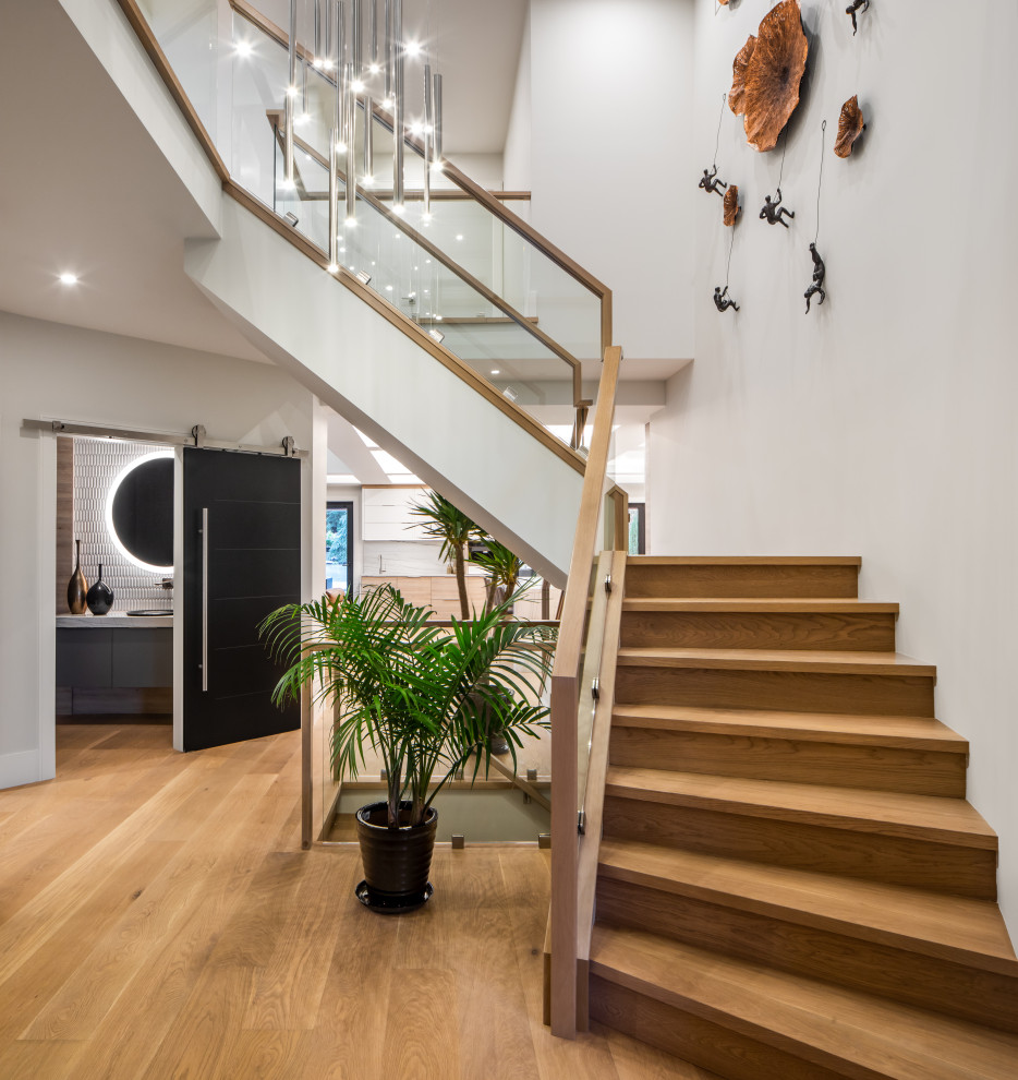 Example of a mid-sized trendy wooden l-shaped glass railing staircase design in Vancouver with wooden risers