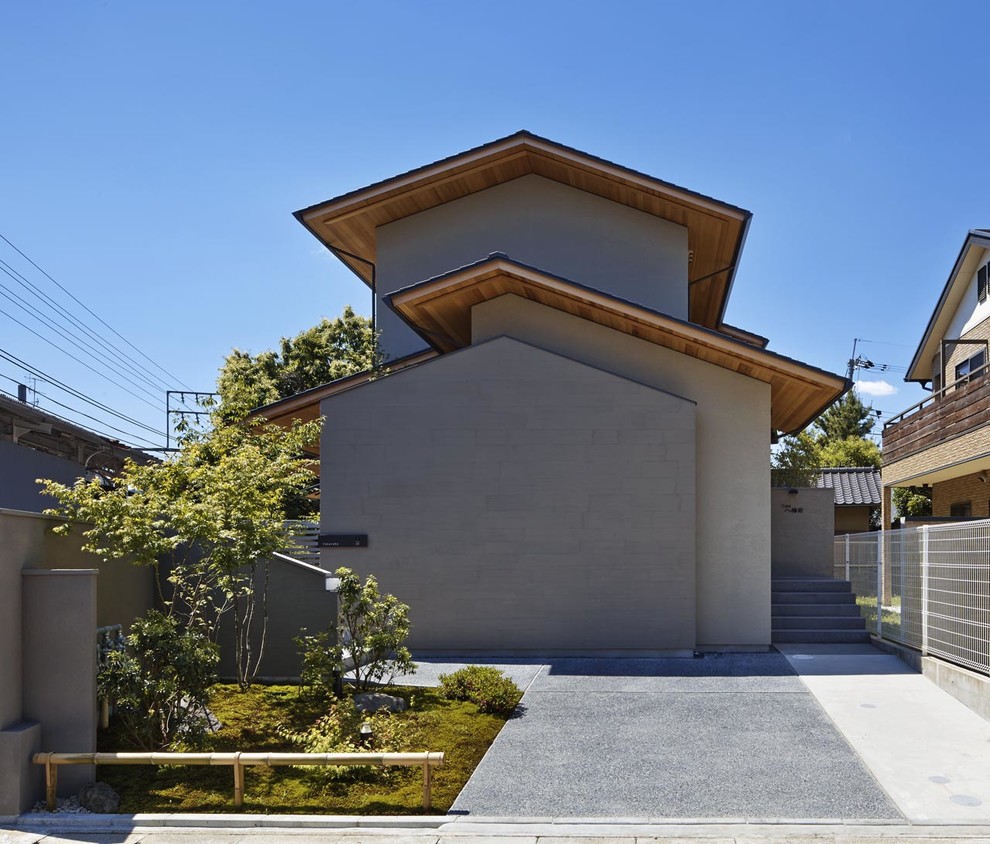 Inspiration for an asian beige exterior in Other with a gable roof.