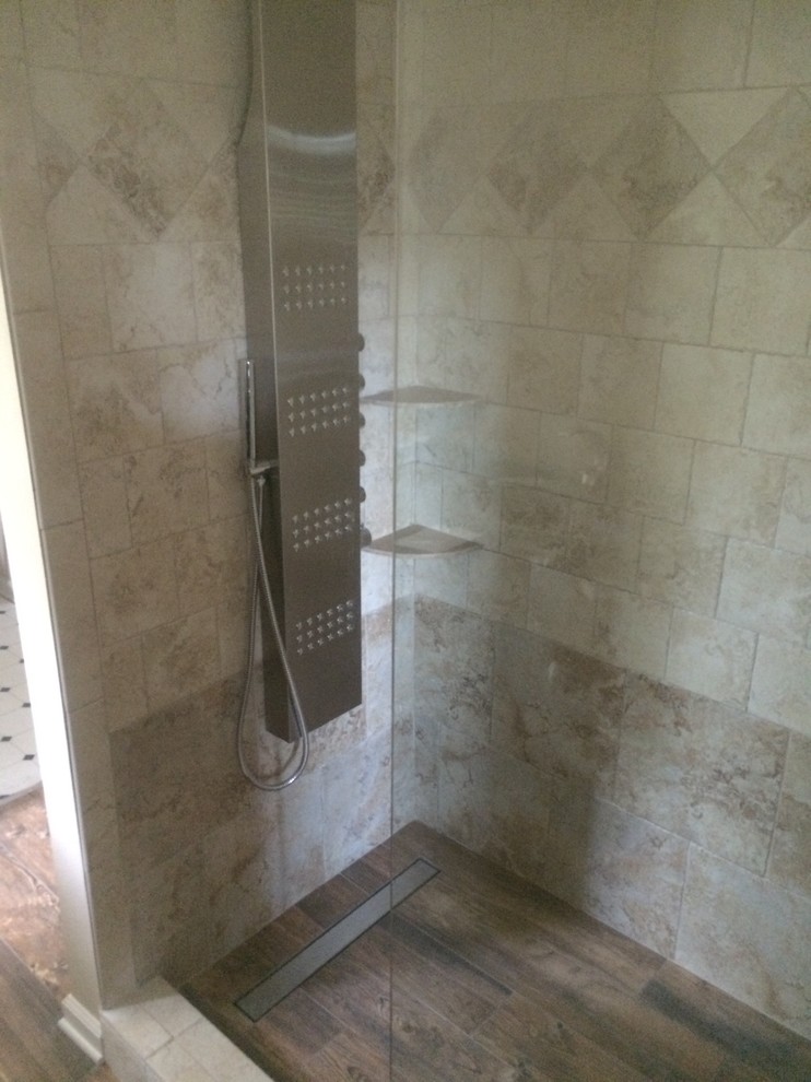 This is an example of a mid-sized contemporary bathroom in Jacksonville with beige tile, porcelain tile, beige walls and porcelain floors.