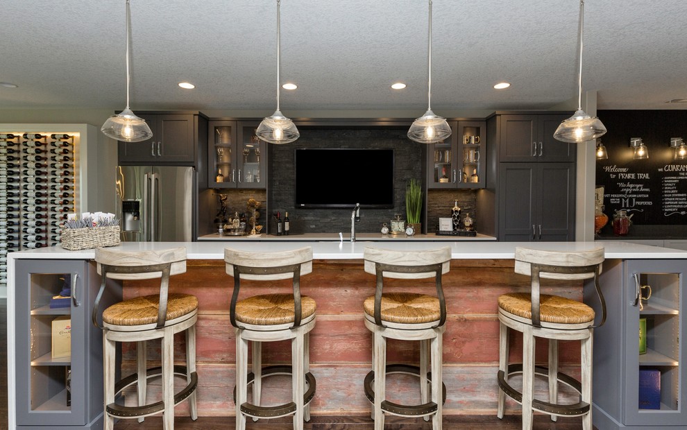 Eat-in kitchen - mid-sized transitional l-shaped dark wood floor eat-in kitchen idea with shaker cabinets, gray cabinets, solid surface countertops, gray backsplash, stone tile backsplash, stainless steel appliances and an island