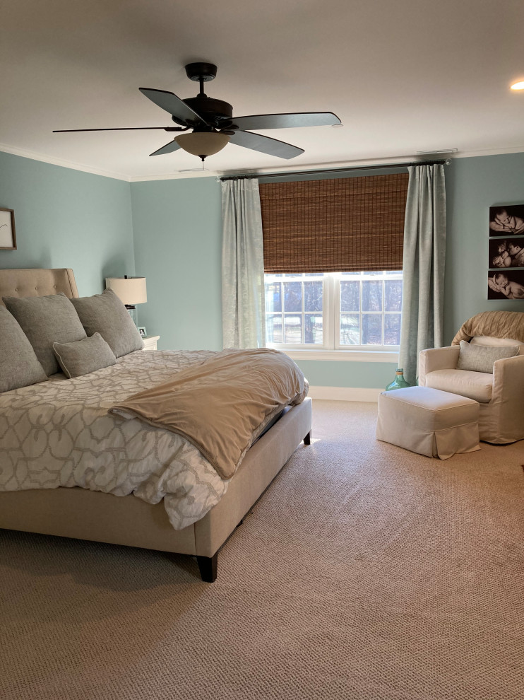 Design ideas for a mid-sized beach style master bedroom in Other with green walls, carpet, a standard fireplace, a stone fireplace surround and beige floor.