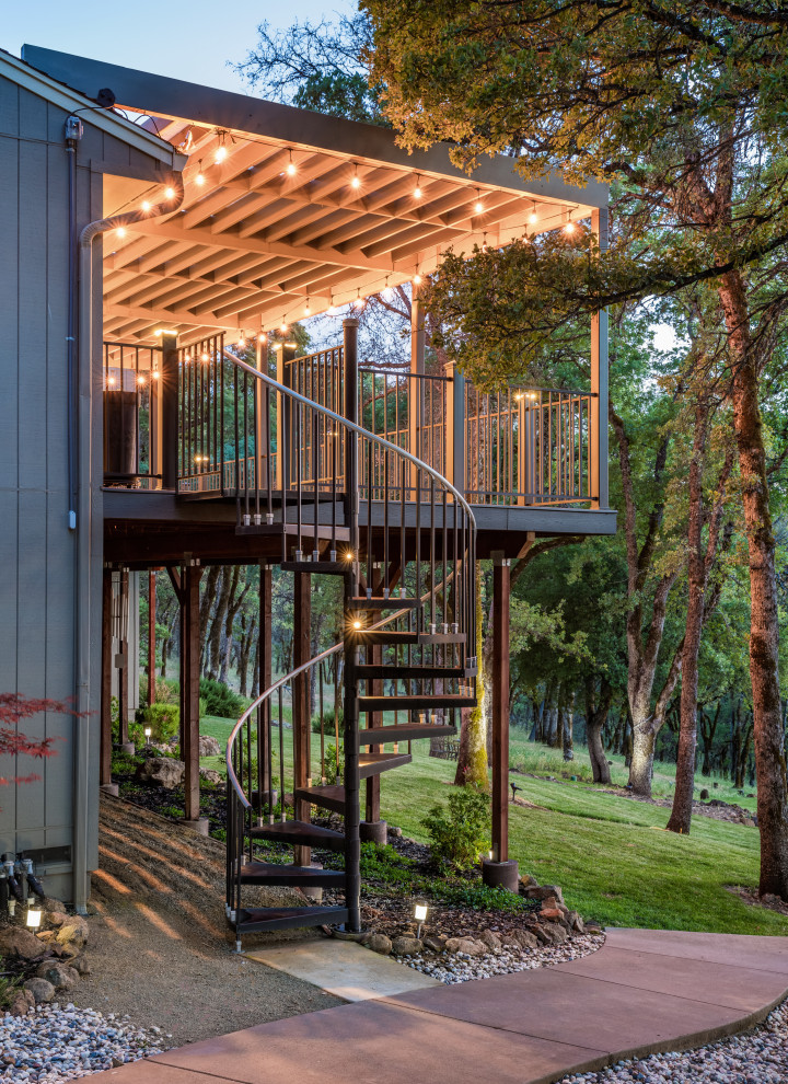 Photo of a mid-sized arts and crafts backyard and first floor deck in Sacramento with a pergola and metal railing.