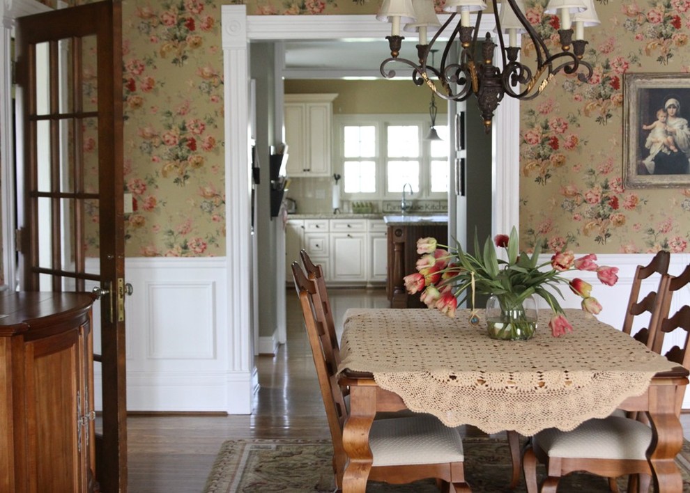 Inspiration for a traditional dining room in New York with multi-coloured walls and dark hardwood floors.