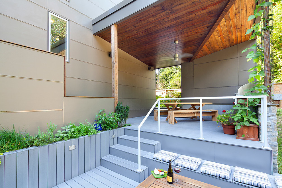 Deck - contemporary deck idea in Baltimore with decking and a roof extension