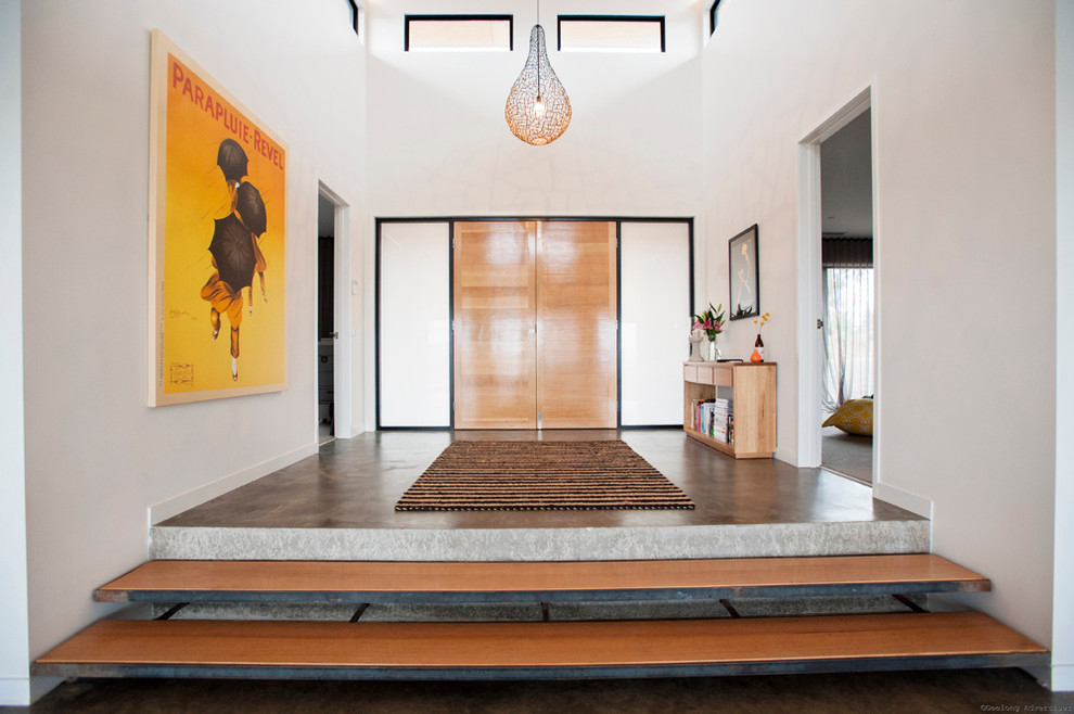 Contemporary foyer in Melbourne with white walls, a double front door and a medium wood front door.