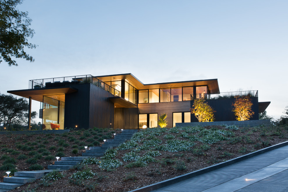 Photo of a contemporary two-storey brown house exterior in San Francisco with wood siding and a flat roof.
