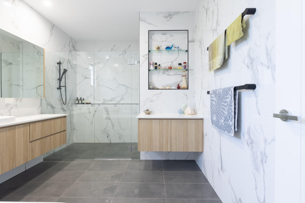 Contemporary bathroom in Brisbane with flat-panel cabinets, light wood cabinets, a curbless shower, white tile, a vessel sink, grey floor, a hinged shower door, white benchtops, a single vanity and a floating vanity.
