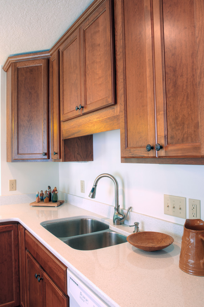 Inspiration for a mid-sized traditional u-shaped eat-in kitchen in Minneapolis with an undermount sink, flat-panel cabinets, medium wood cabinets, granite benchtops, white appliances, medium hardwood floors and no island.