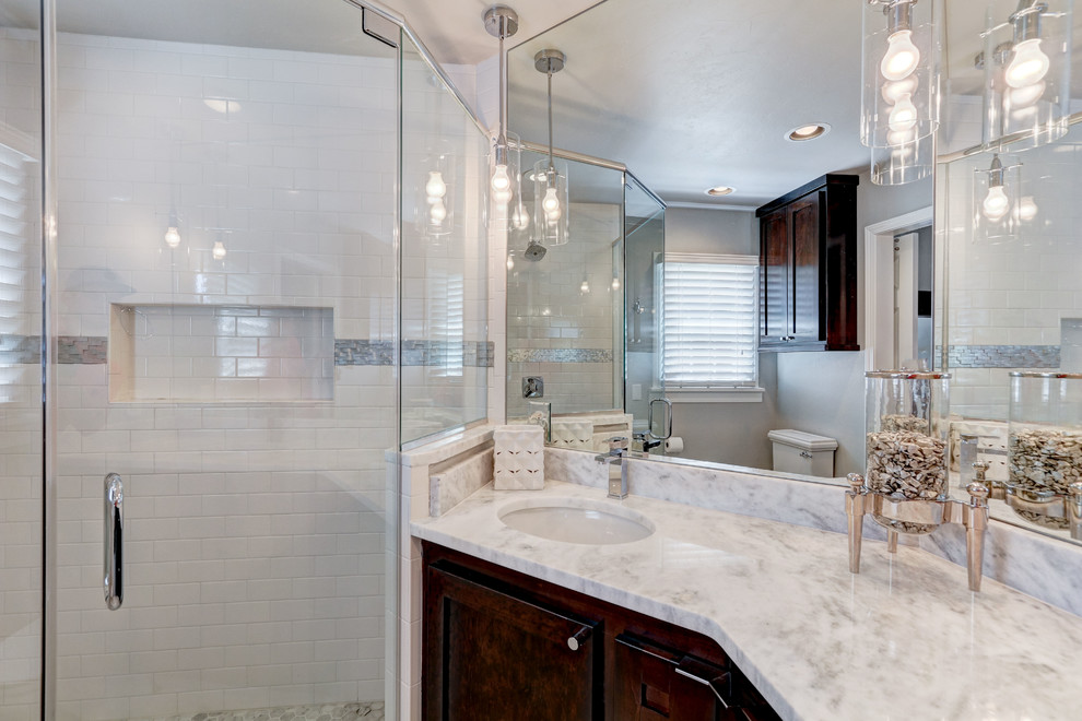 This is an example of a small transitional master bathroom in Oklahoma City with shaker cabinets, dark wood cabinets, mosaic tile, marble benchtops, a corner shower, gray tile, grey walls and marble floors.
