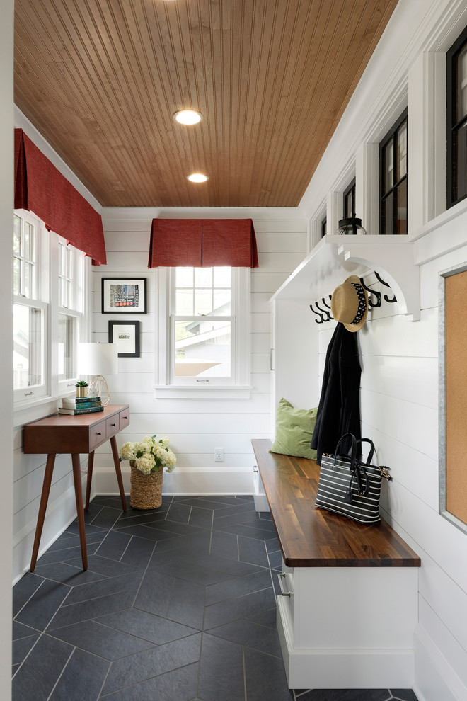 Traditional mudroom in Minneapolis with white walls and black floor.