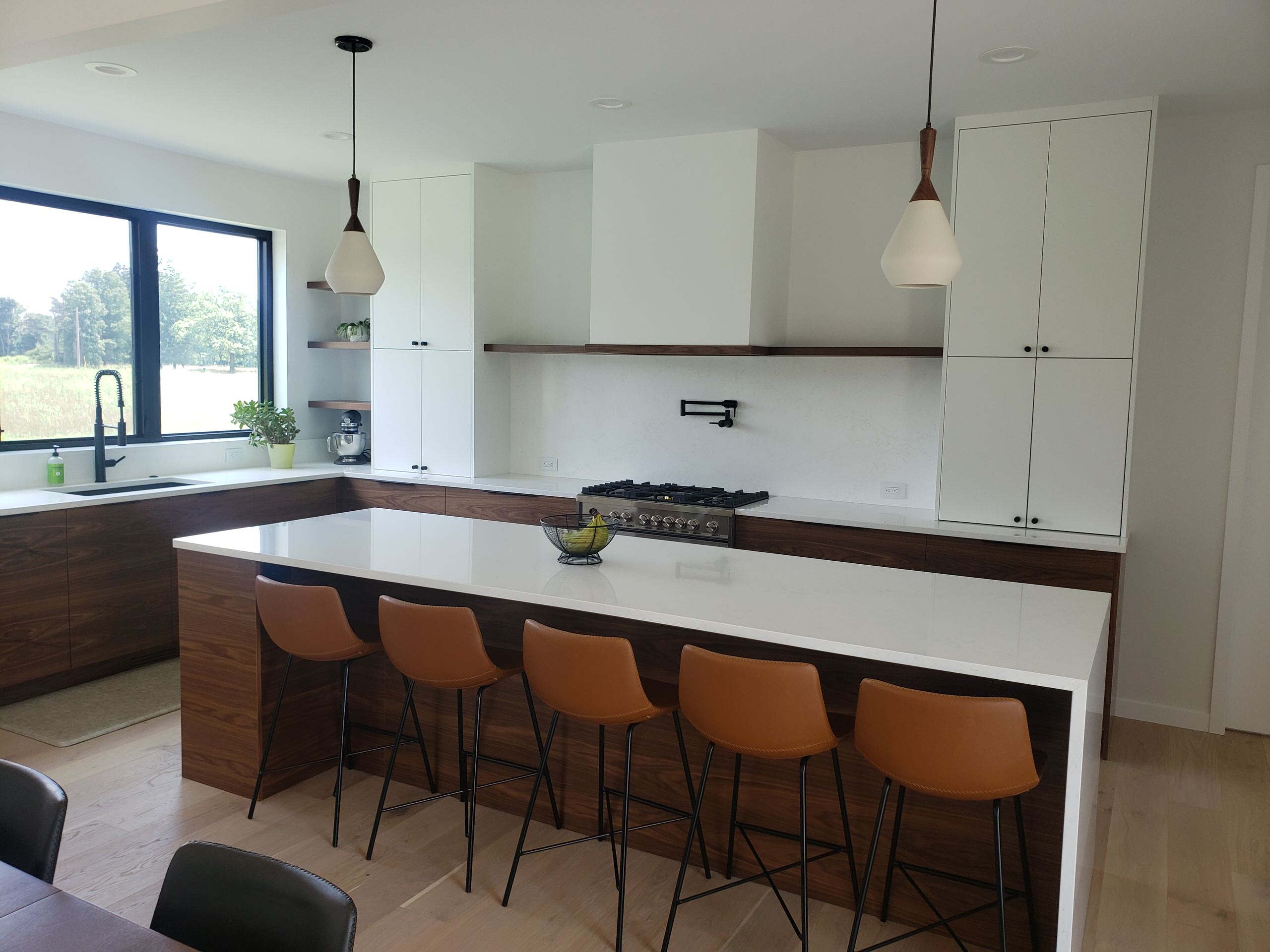 New kitchen with grain match custom cabinets, and waterflow countertop.