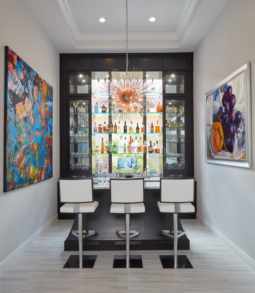 This is an example of a mid-sized contemporary single-wall seated home bar in Miami with open cabinets, black cabinets, marble benchtops, grey floor and white benchtop.