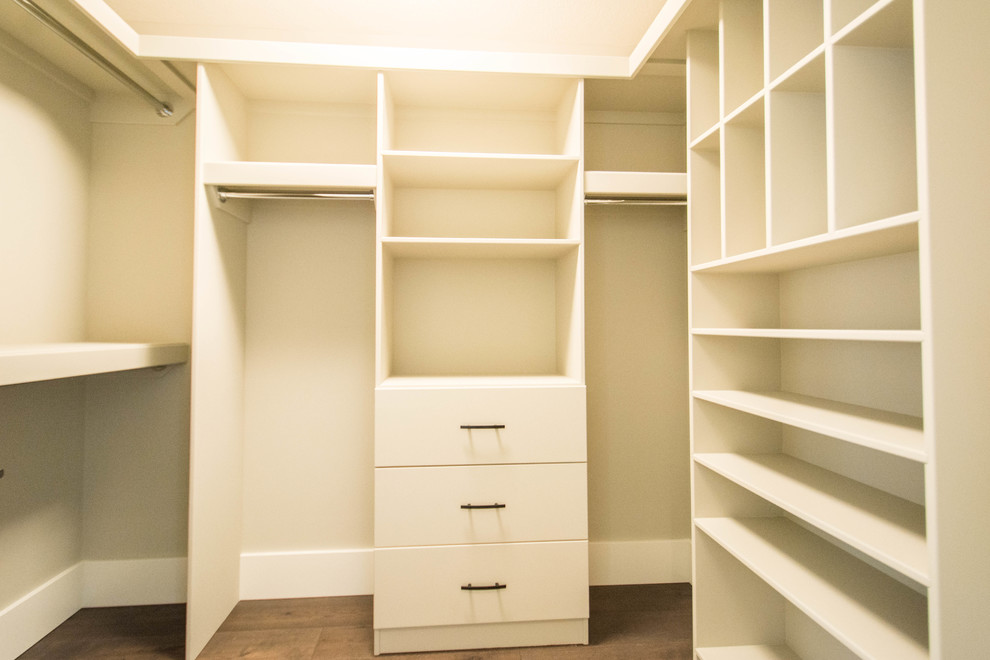 Design ideas for a mid-sized traditional gender-neutral walk-in wardrobe in Calgary with open cabinets, red cabinets, medium hardwood floors and brown floor.