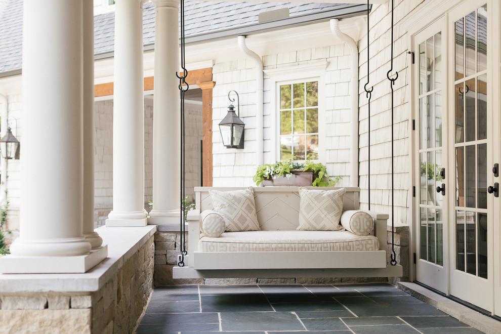 Inspiration for a small transitional backyard verandah in Atlanta with a roof extension and tile.