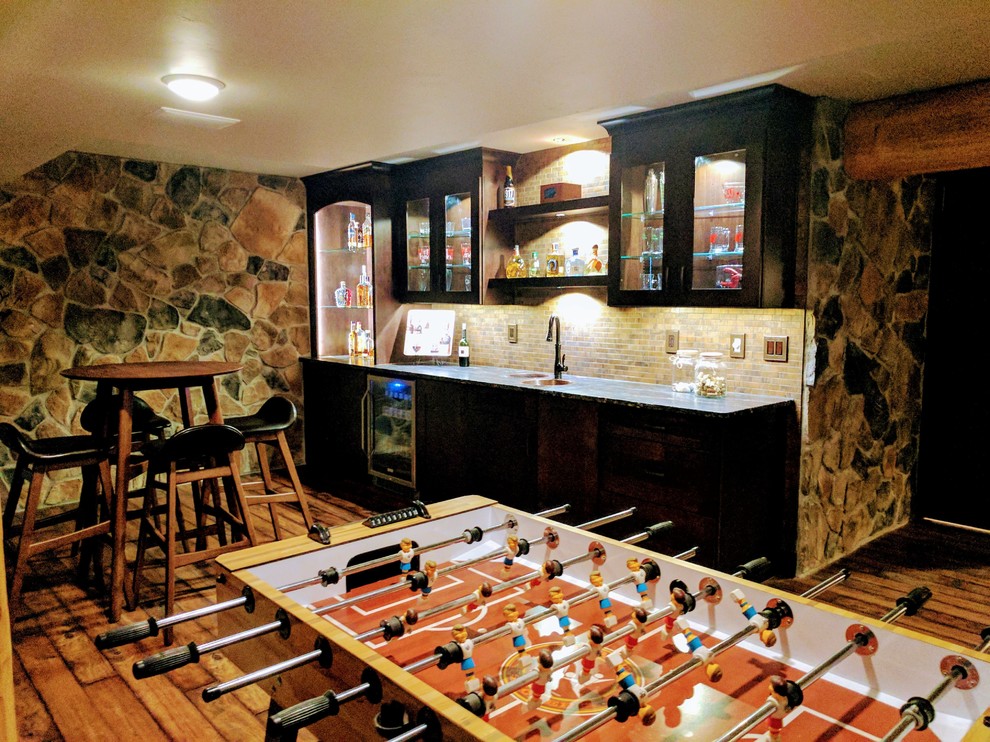Inspiration for a large rustic underground medium tone wood floor and brown floor basement remodel with gray walls and no fireplace