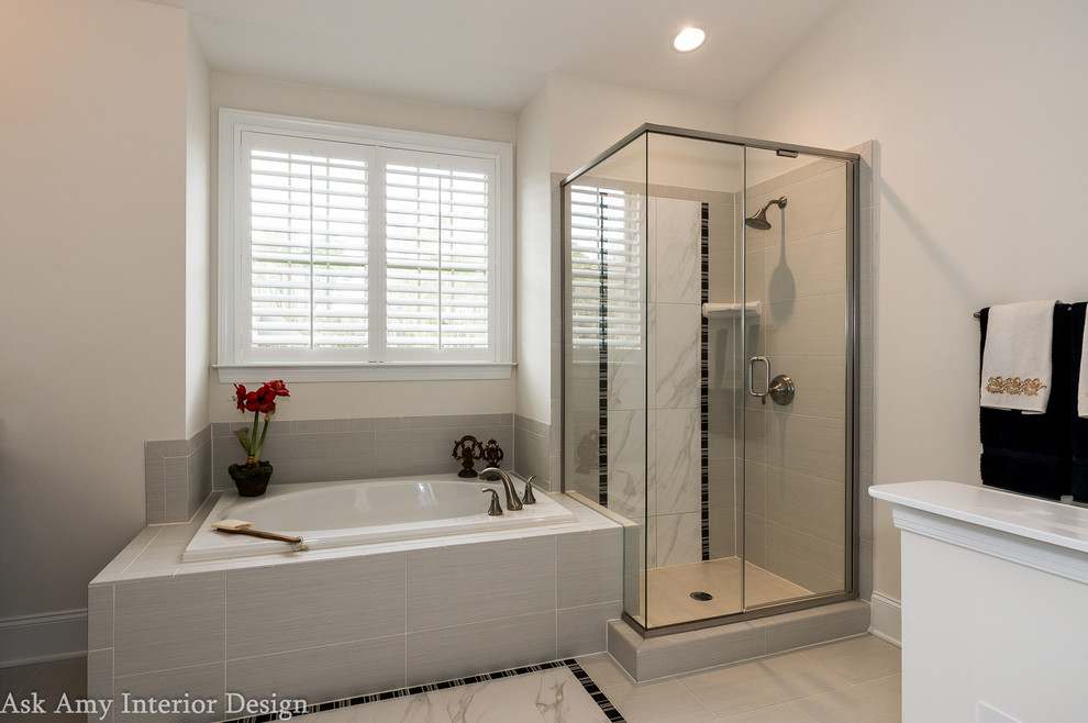 Photo of a large modern master bathroom in Charlotte with shaker cabinets, dark wood cabinets, a drop-in tub, an open shower, a one-piece toilet, gray tile, cement tile, grey walls, ceramic floors, an undermount sink and granite benchtops.
