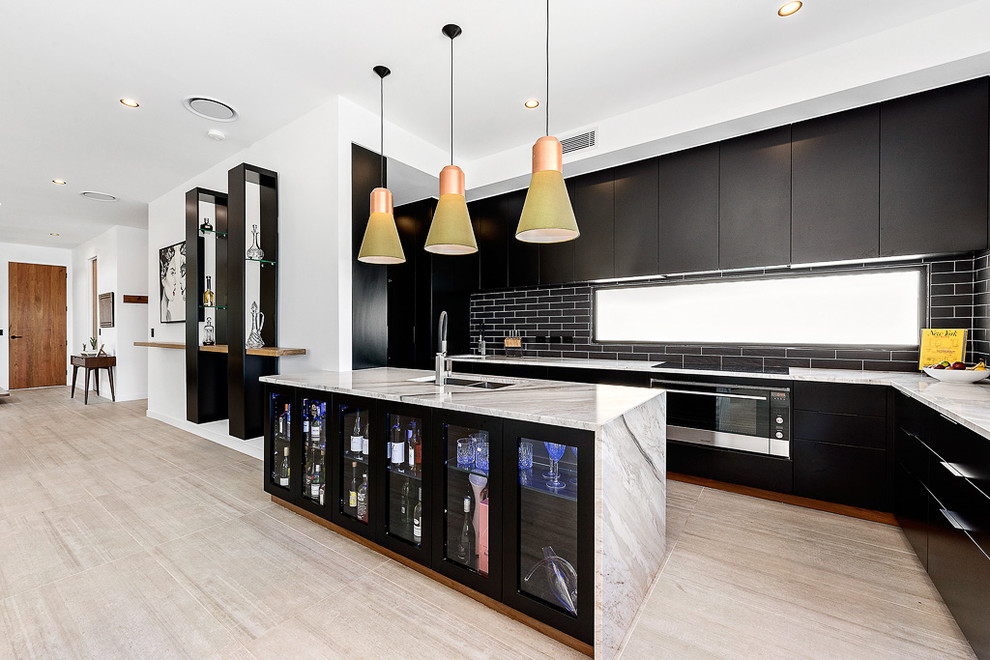 This is an example of a large contemporary single-wall eat-in kitchen in Brisbane with an undermount sink, flat-panel cabinets, black cabinets, granite benchtops, black splashback, subway tile splashback, stainless steel appliances, porcelain floors, with island and beige floor.