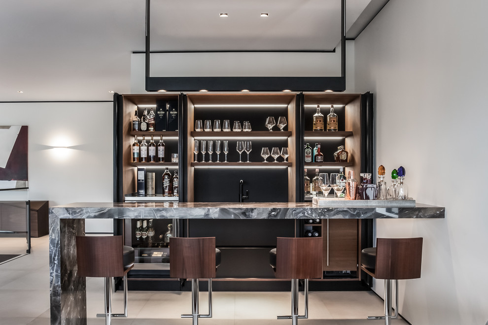 Design ideas for a large contemporary galley wet bar in Miami with dark wood cabinets, marble benchtops, brown splashback, porcelain floors and open cabinets.