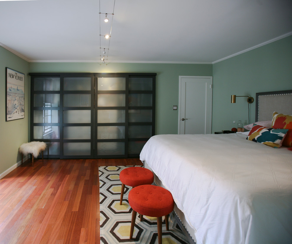 Photo of a mid-sized eclectic master bedroom in San Francisco with green walls, medium hardwood floors and no fireplace.