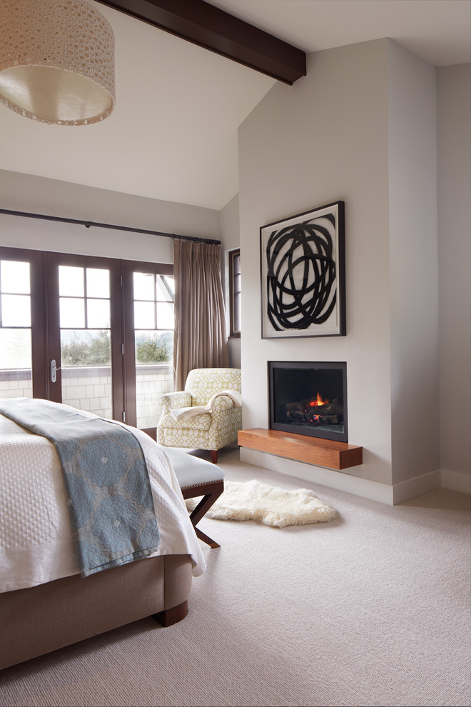 Photo of a mid-sized contemporary master bedroom in San Francisco with beige walls, carpet, a standard fireplace and a plaster fireplace surround.