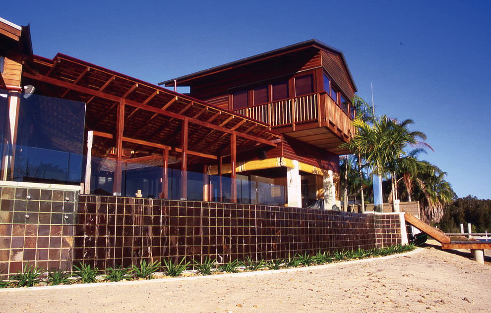 Photo of a beach style home design in Brisbane.